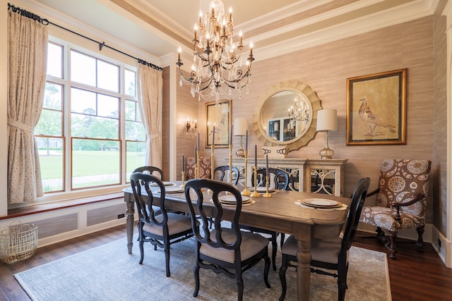 dining area with dark hardwood / wood-style flooring, a notable chandelier, and ornamental molding