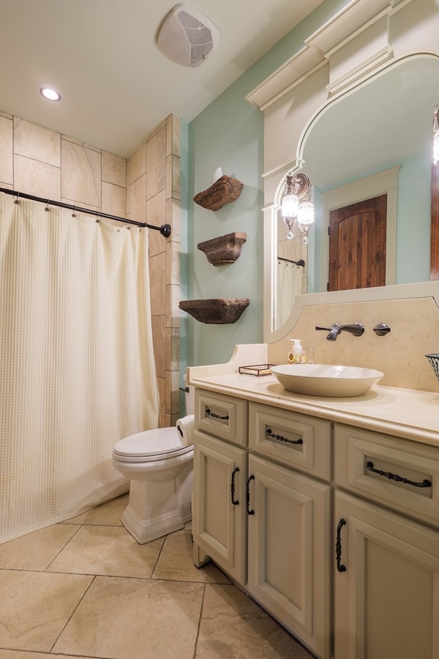 bathroom with tile patterned floors, vanity, toilet, and a shower with curtain