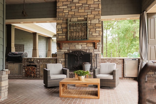 living area with an outdoor stone fireplace