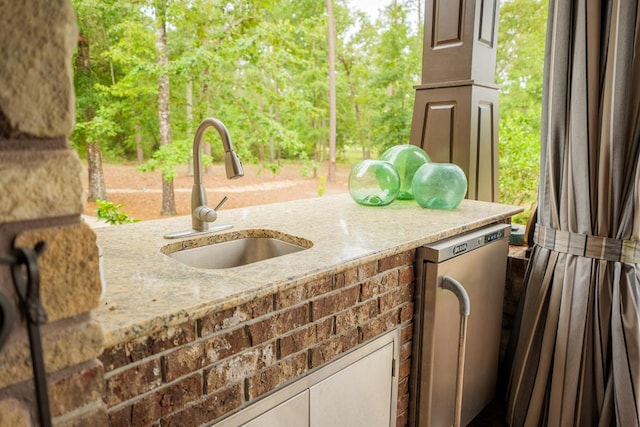 exterior space featuring an outdoor kitchen and sink