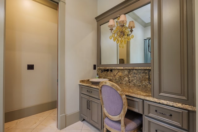 bathroom featuring tile patterned flooring, vanity, and a chandelier