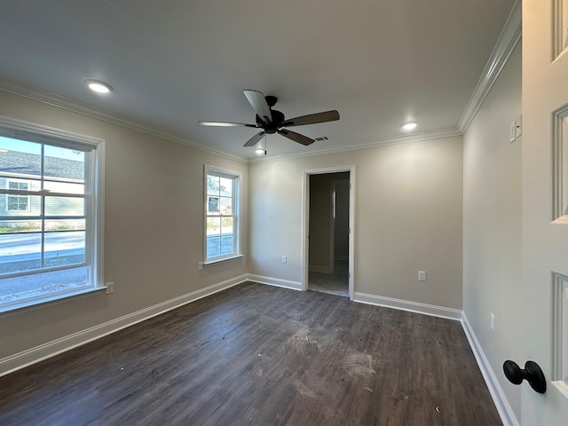 spare room featuring crown molding, ceiling fan, and dark hardwood / wood-style floors