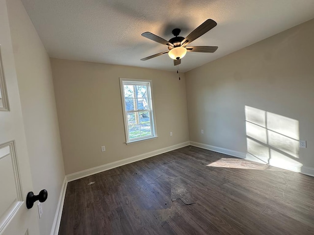 unfurnished room featuring a textured ceiling, dark hardwood / wood-style flooring, and ceiling fan