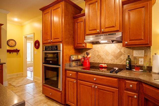 kitchen with crown molding, backsplash, double oven, black electric stovetop, and under cabinet range hood
