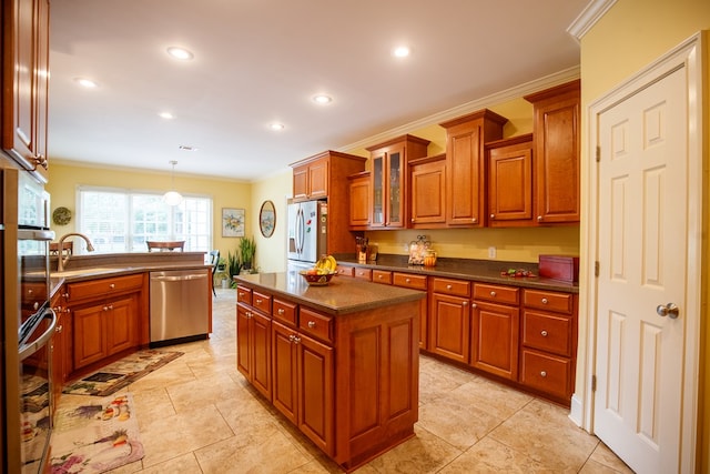 kitchen with sink, a center island, ornamental molding, pendant lighting, and stainless steel appliances