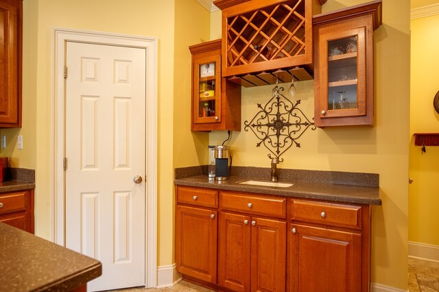 kitchen featuring crown molding, fridge, and light tile patterned flooring