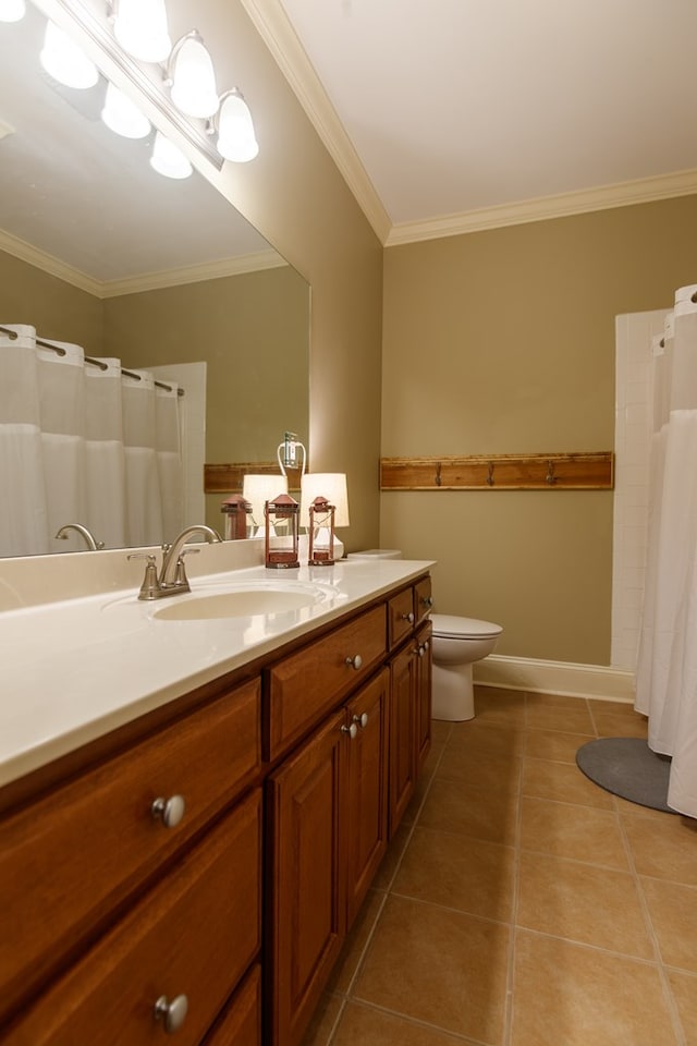 full bathroom featuring tile patterned flooring, vanity, crown molding, toilet, and baseboards