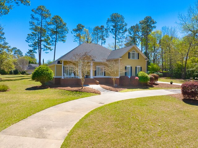 view of front facade with a front yard and concrete driveway