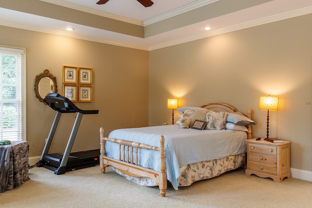 bedroom with crown molding, a raised ceiling, ceiling fan, and carpet flooring