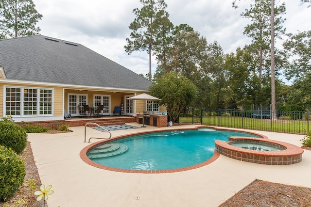 view of swimming pool with french doors, a pool with connected hot tub, fence, and a patio area