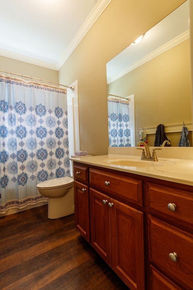 bathroom featuring crown molding, hardwood / wood-style floors, vanity, and toilet