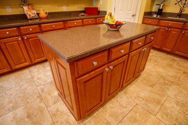 kitchen featuring crown molding, stainless steel fridge, kitchen peninsula, and a kitchen bar