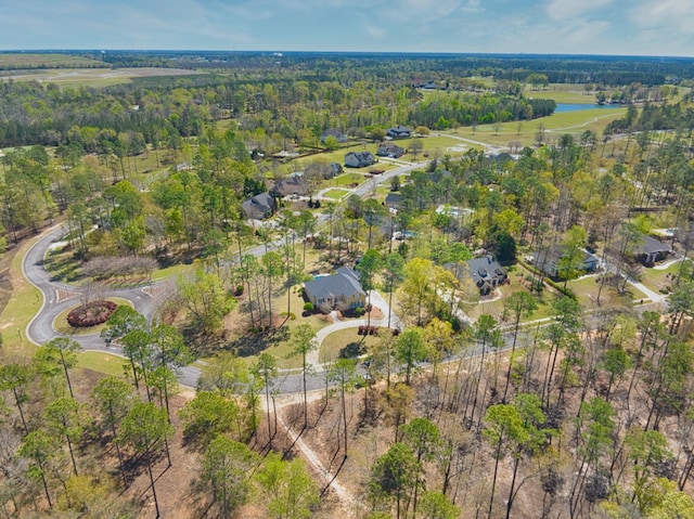birds eye view of property featuring a forest view