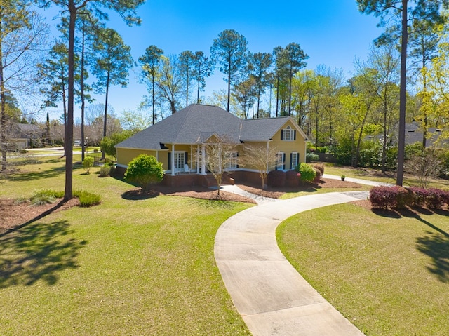 view of front facade with a front lawn and covered porch