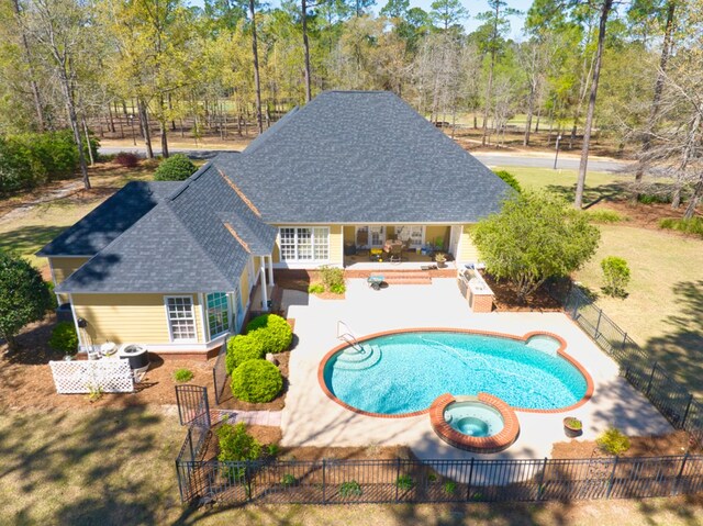 view of pool featuring a pool with connected hot tub, fence private yard, and a patio area