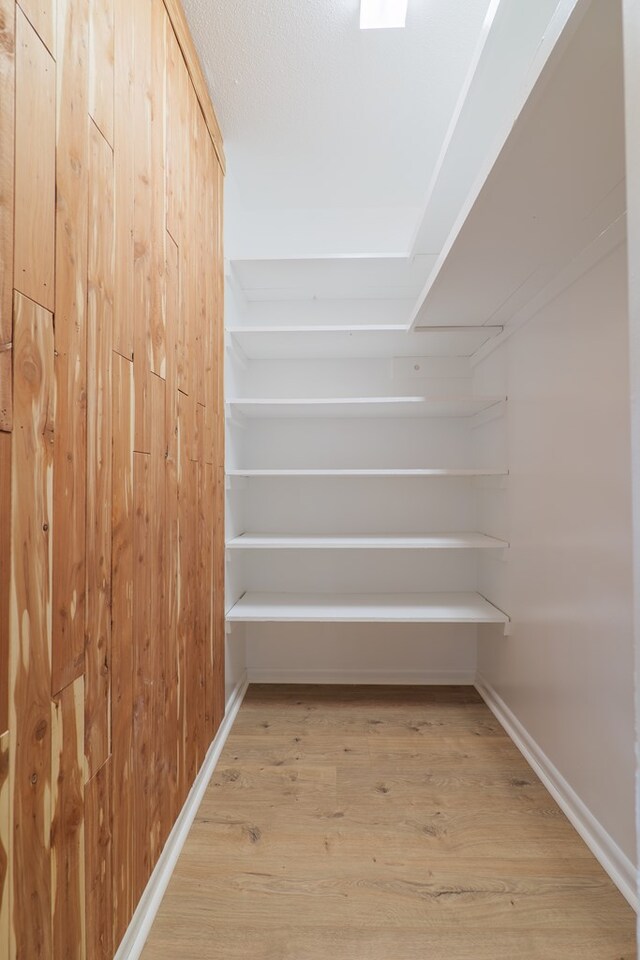 spacious closet featuring light hardwood / wood-style flooring