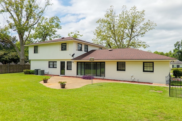 rear view of house with a lawn, central air condition unit, and a patio