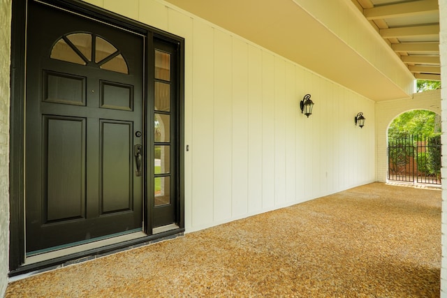 view of exterior entry featuring covered porch