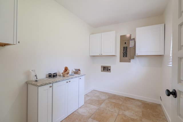 laundry area featuring hookup for a washing machine, cabinets, and electric panel