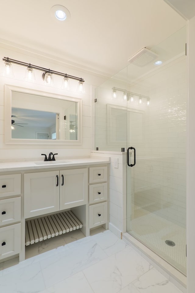 bathroom with ceiling fan, vanity, and an enclosed shower