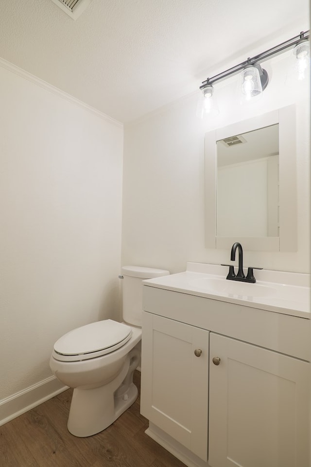 bathroom featuring hardwood / wood-style floors, vanity, and toilet