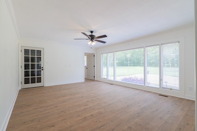 spare room featuring light hardwood / wood-style flooring, ceiling fan, and ornamental molding