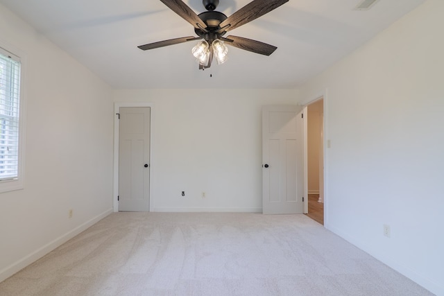 carpeted empty room with ceiling fan