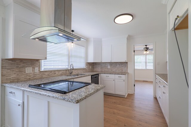 kitchen featuring black appliances, sink, light hardwood / wood-style flooring, white cabinetry, and island exhaust hood