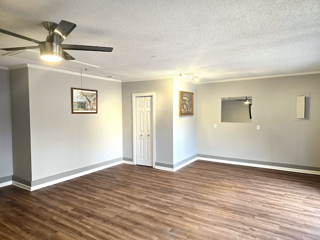 spare room with a textured ceiling, dark hardwood / wood-style floors, ceiling fan, and crown molding