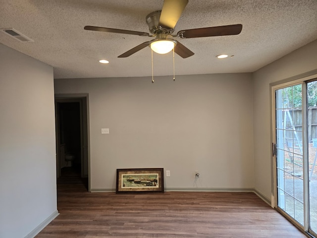 empty room featuring wood-type flooring, a textured ceiling, and ceiling fan