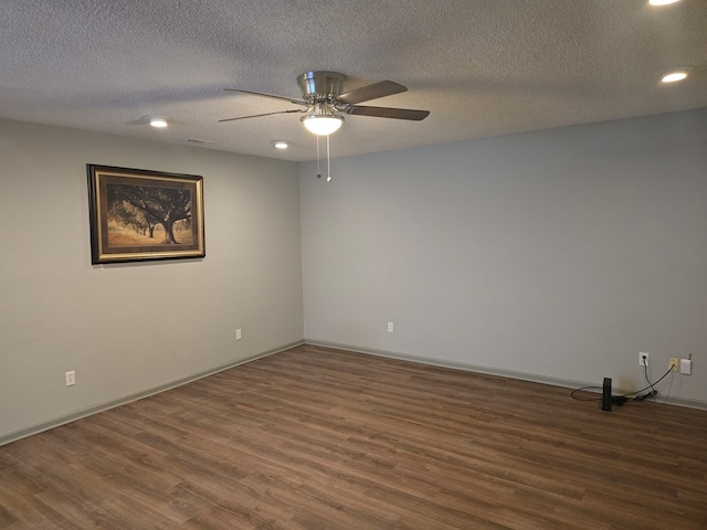 empty room featuring a textured ceiling, ceiling fan, and dark hardwood / wood-style floors