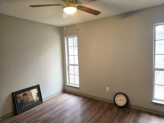 empty room with hardwood / wood-style flooring, ceiling fan, and a textured ceiling