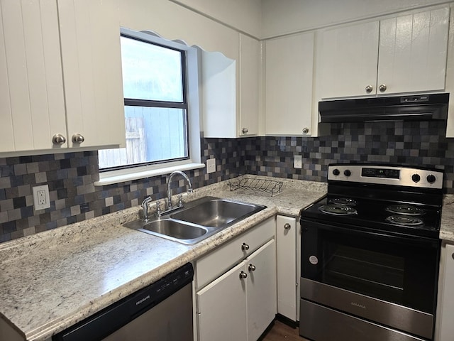 kitchen with decorative backsplash, appliances with stainless steel finishes, light stone counters, sink, and white cabinetry