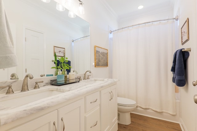 bathroom featuring shower / bathtub combination with curtain, toilet, ornamental molding, a sink, and wood finished floors