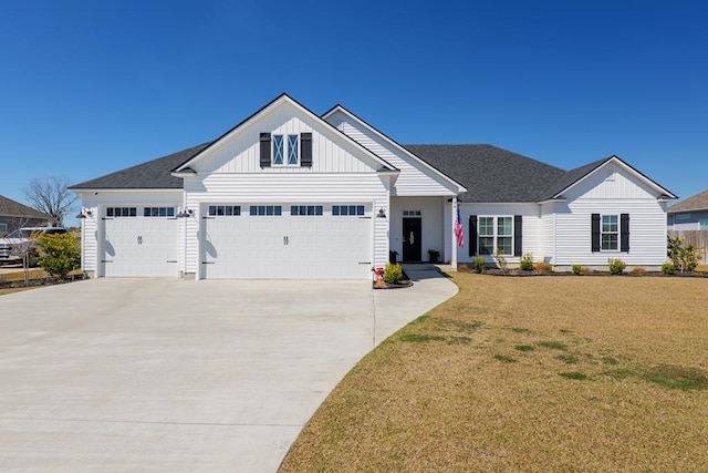 view of front of home with a garage, concrete driveway, roof with shingles, board and batten siding, and a front yard