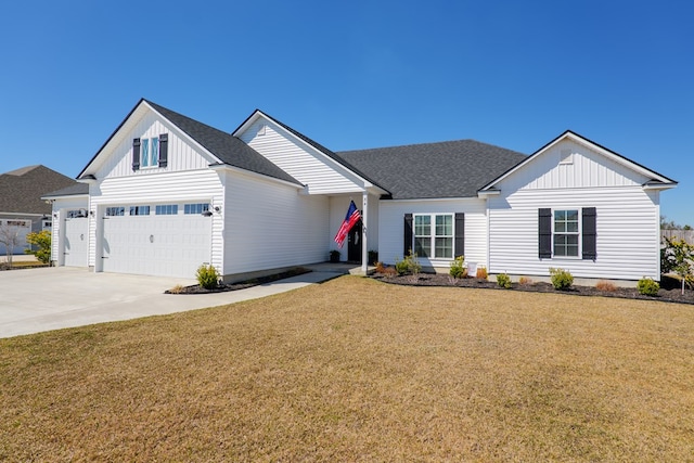 modern inspired farmhouse with driveway, a shingled roof, board and batten siding, and a front yard