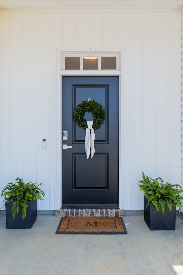 view of exterior entry with board and batten siding