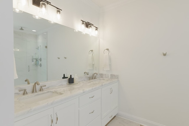 full bathroom featuring baseboards, crown molding, a shower stall, and a sink