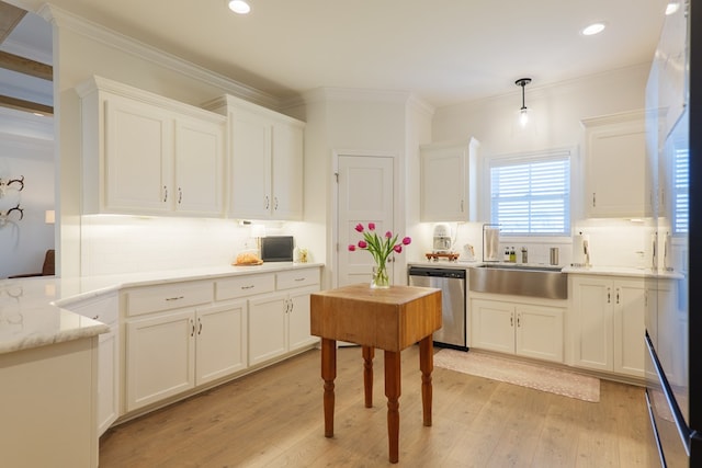 kitchen featuring a sink, white cabinets, stainless steel dishwasher, light wood finished floors, and crown molding