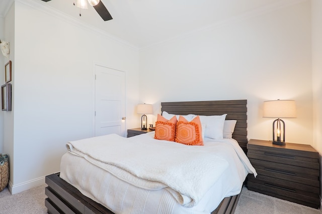 carpeted bedroom featuring baseboards, ornamental molding, and a ceiling fan