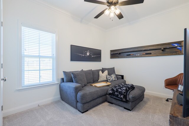 carpeted living area featuring baseboards, a ceiling fan, and crown molding