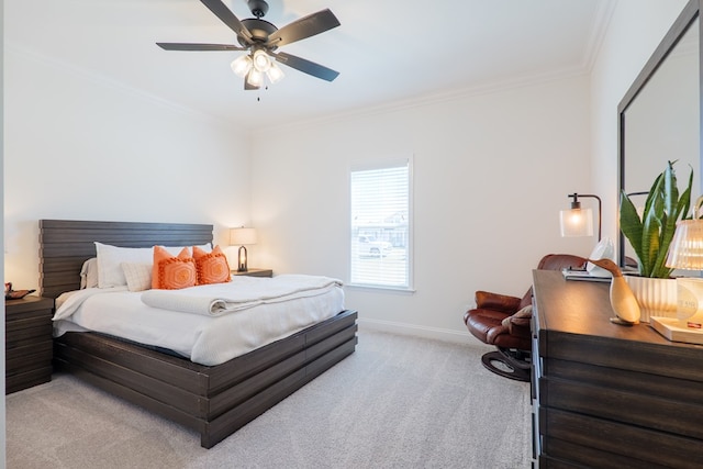 bedroom with a ceiling fan, baseboards, crown molding, and light colored carpet