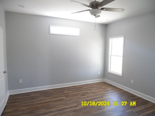 spare room featuring ceiling fan and dark wood-type flooring