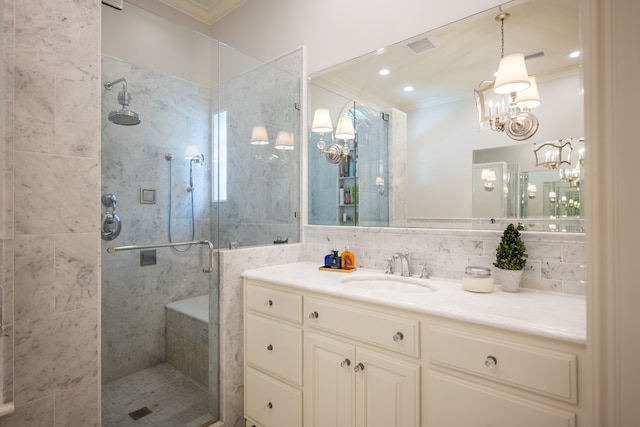 793 Lake Laurie Dr, Valdosta, GA 31605 - bathroom with vanity, a shower stall, tasteful backsplash, ornamental molding, and an inviting chandelier