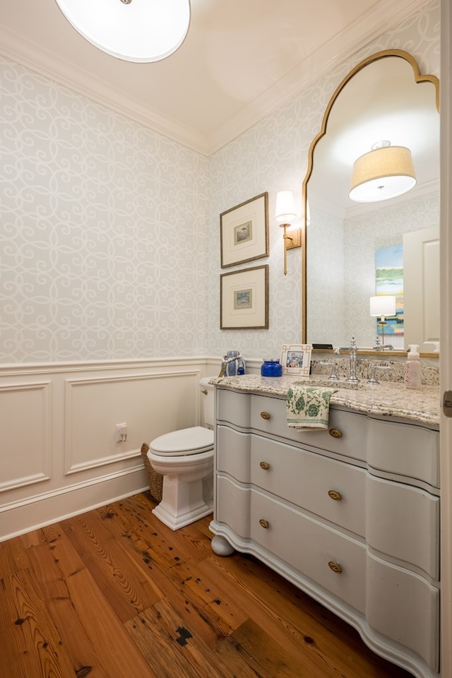 793 Lake Laurie Dr, Valdosta, GA 31605 - half bath featuring a wainscoted wall, crown molding, toilet, wood finished floors, and wallpapered walls