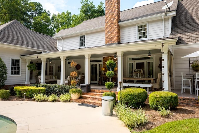 793 Lake Laurie Dr, Valdosta, GA 31605 - rear view of property with a chimney and covered porch