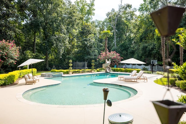 793 Lake Laurie Dr, Valdosta, GA 31605 - view of pool with fence, a trampoline, a water slide, and a patio area