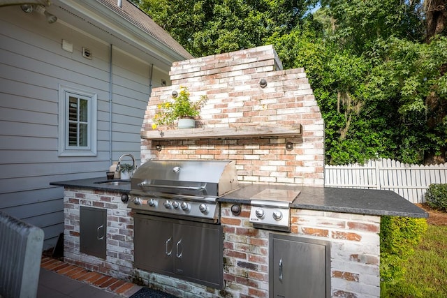 793 Lake Laurie Dr, Valdosta, GA 31605 - view of patio featuring an outdoor kitchen, grilling area, a sink, and fence