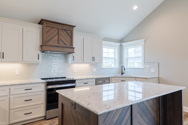 144 Audrey Ln, Hahira, GA 31632 - kitchen featuring electric range oven, a sink, light wood-type flooring, a kitchen island, and dishwasher