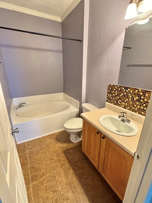 bathroom with tile patterned floors, vanity, crown molding, a bath, and toilet